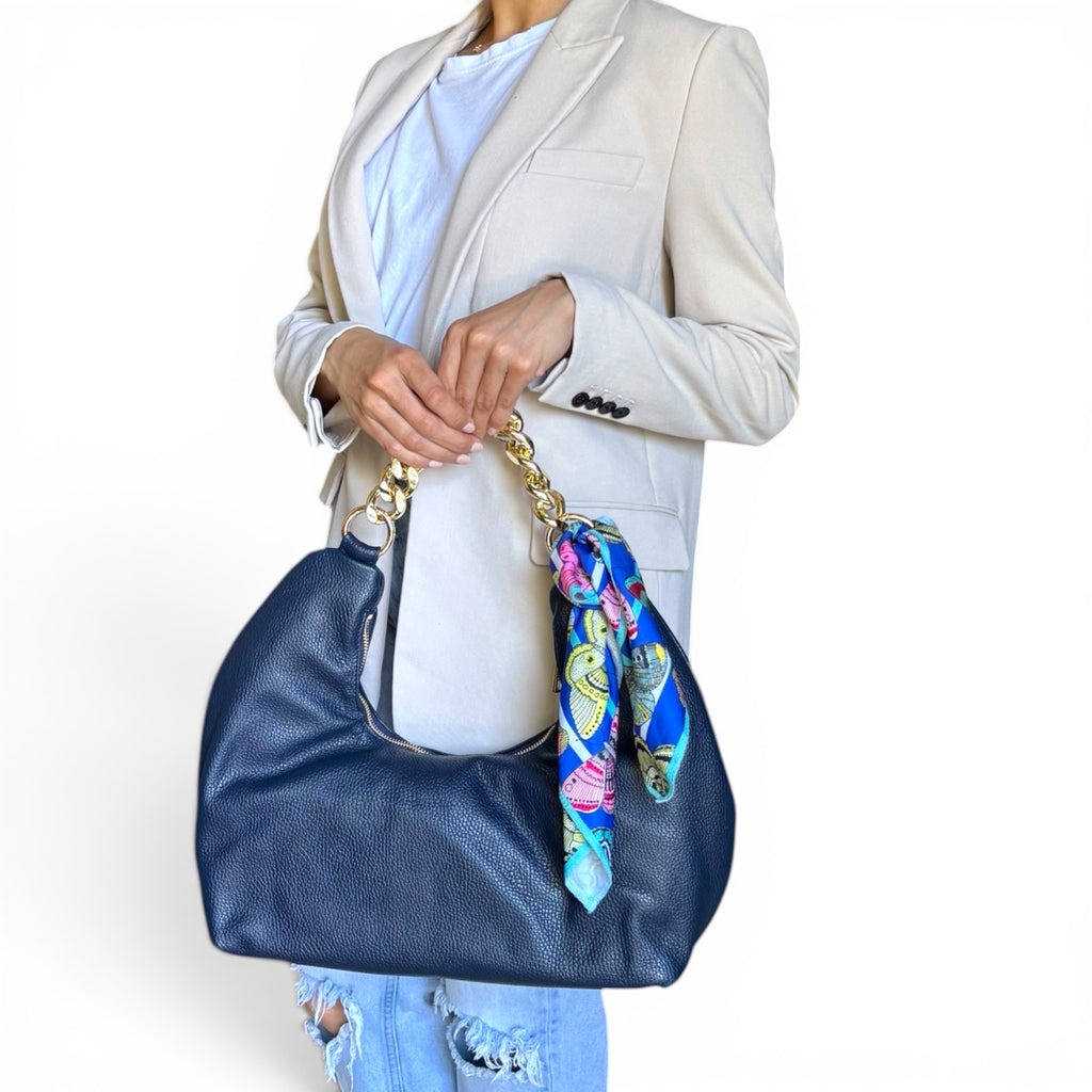 model holding fiorenza dark blue handbag with a colorful scarf attached