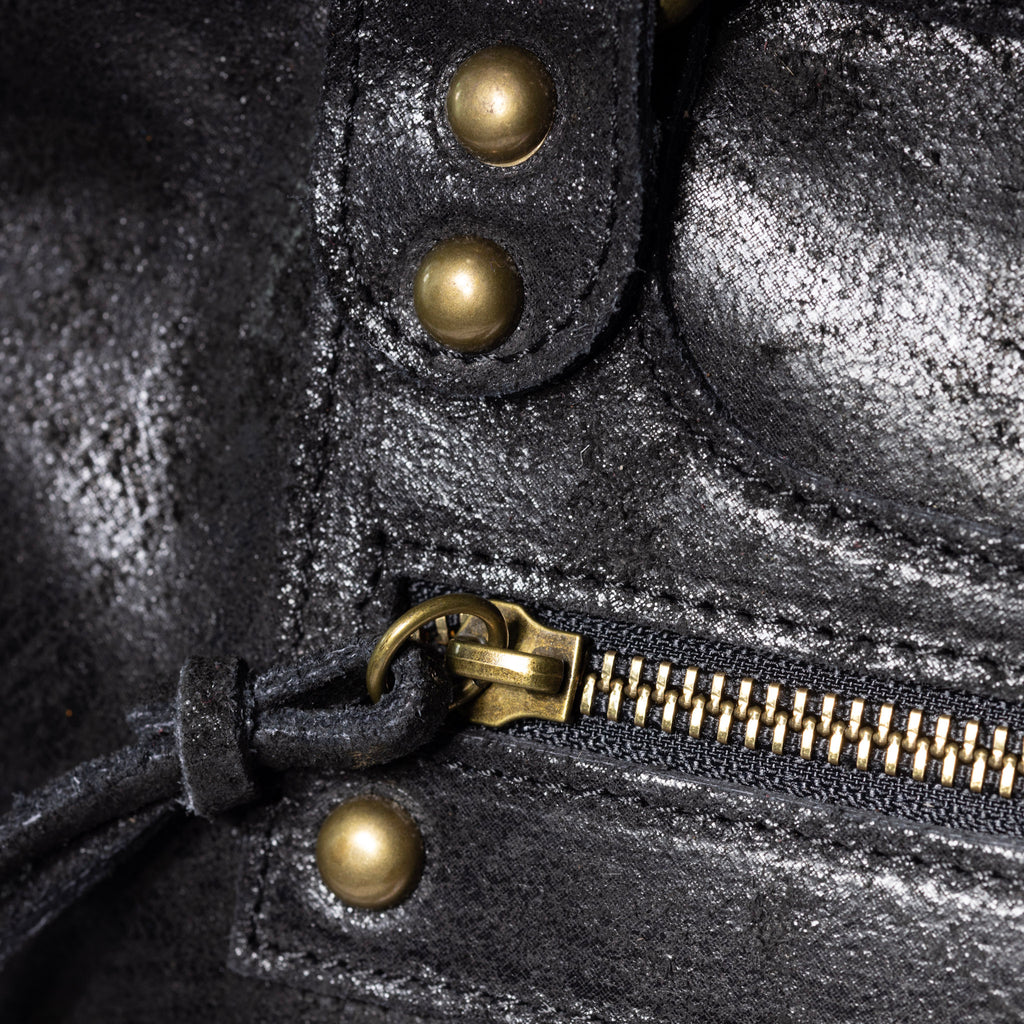 Antique brass hardware on distressed leather handbag