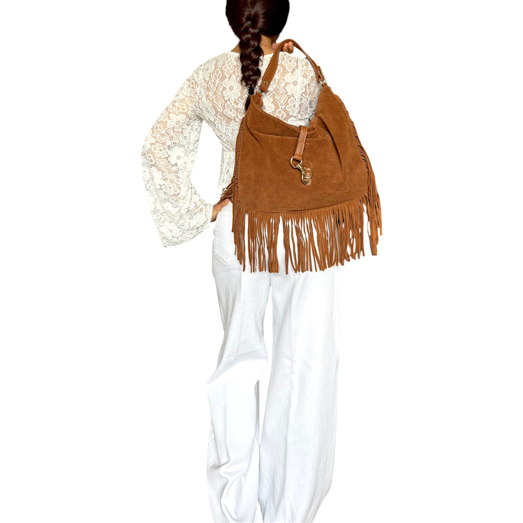 Camel brown suede fringe bag styled as an everyday shoulder bag
