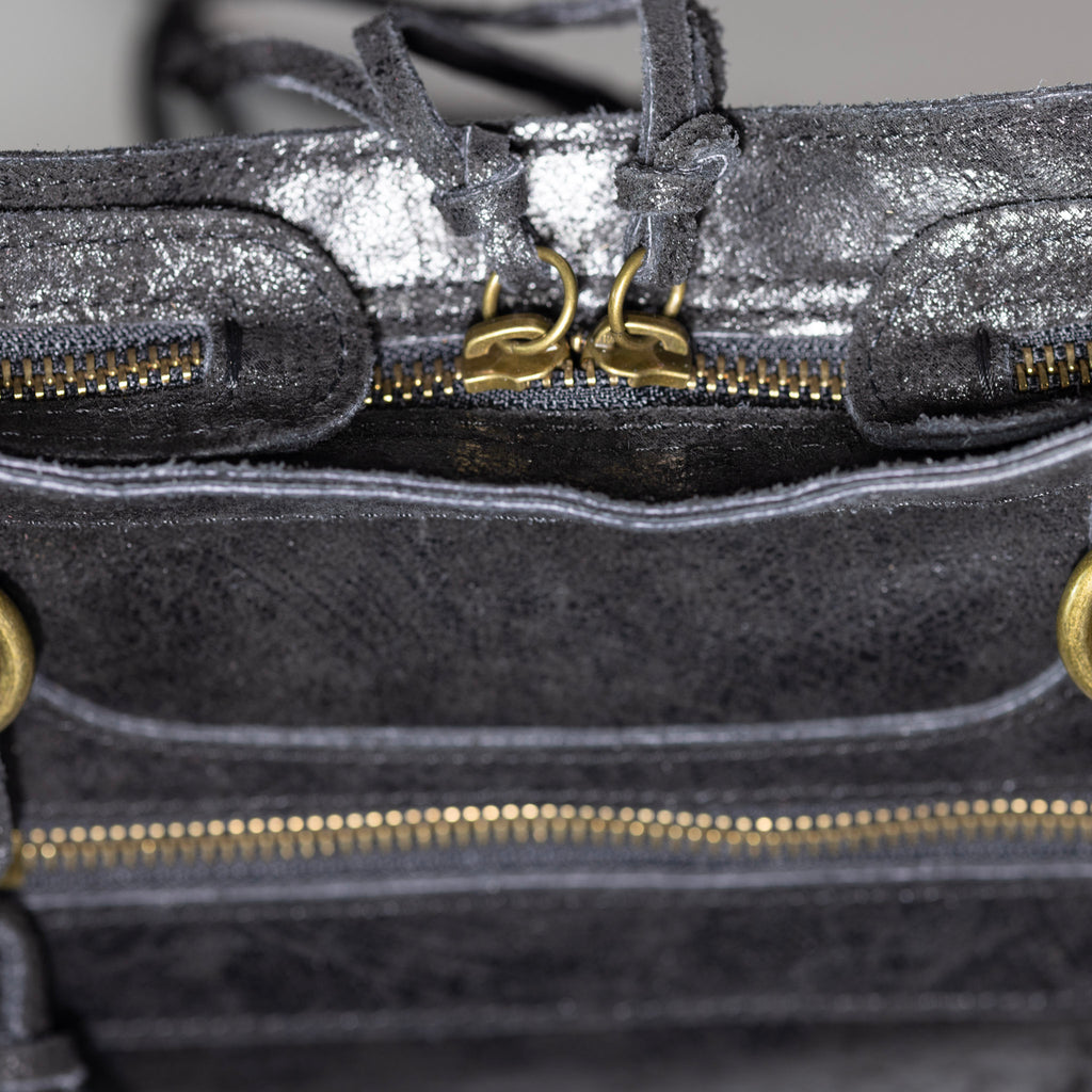 Distressed leather zipper and artisan craftsmanship detail