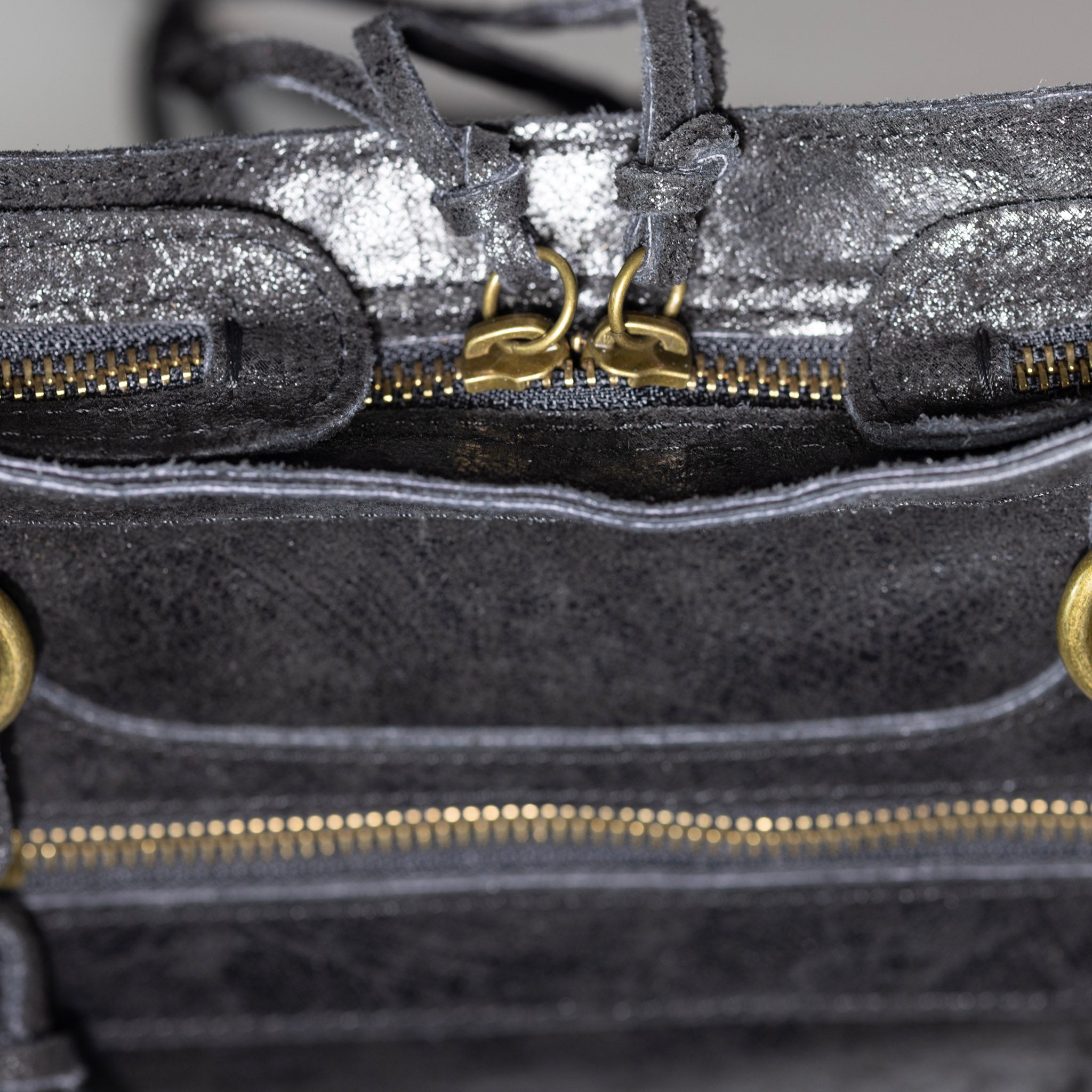 Distressed leather zipper and artisan craftsmanship detail