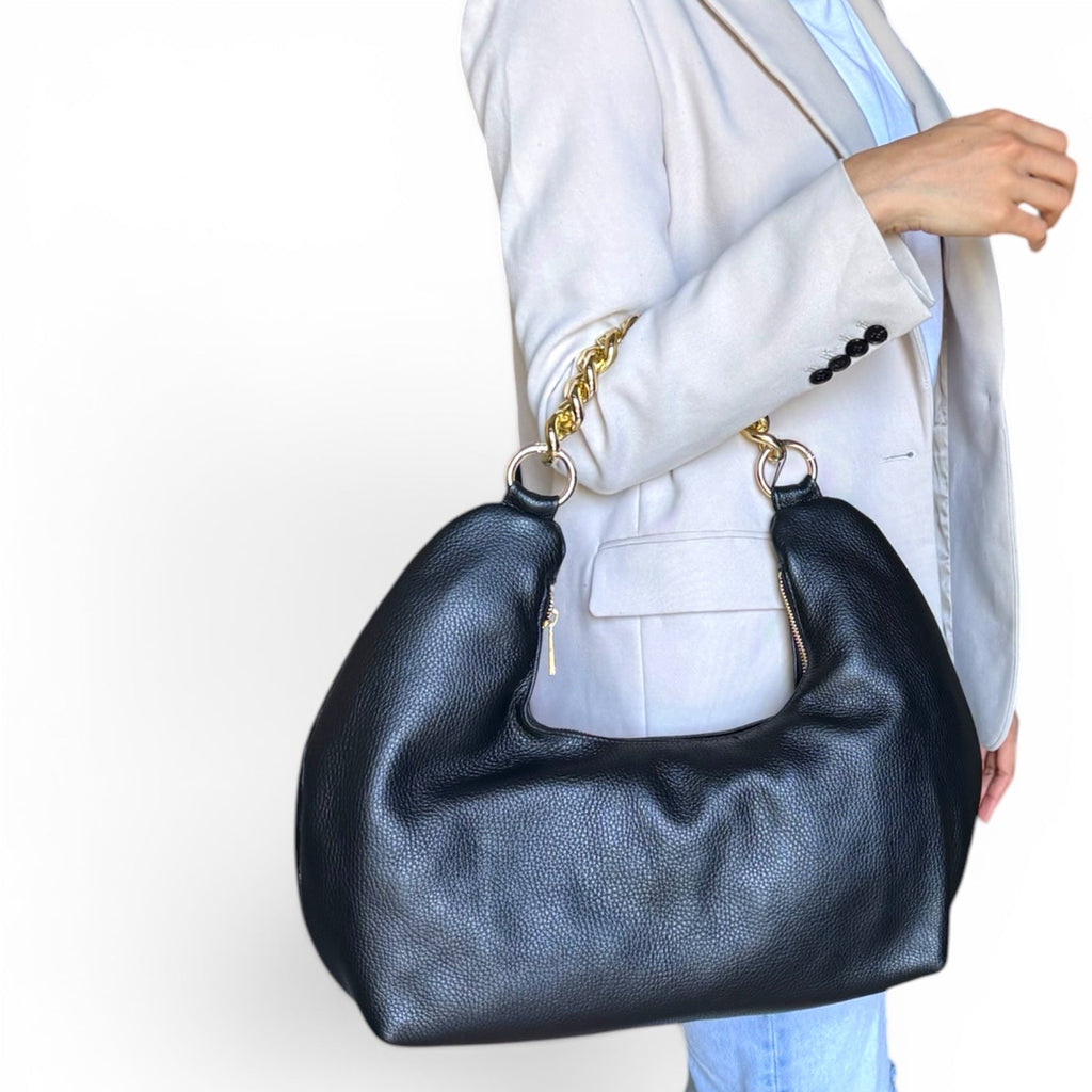 model holding fiorenza black convertible leather handbag with a white background