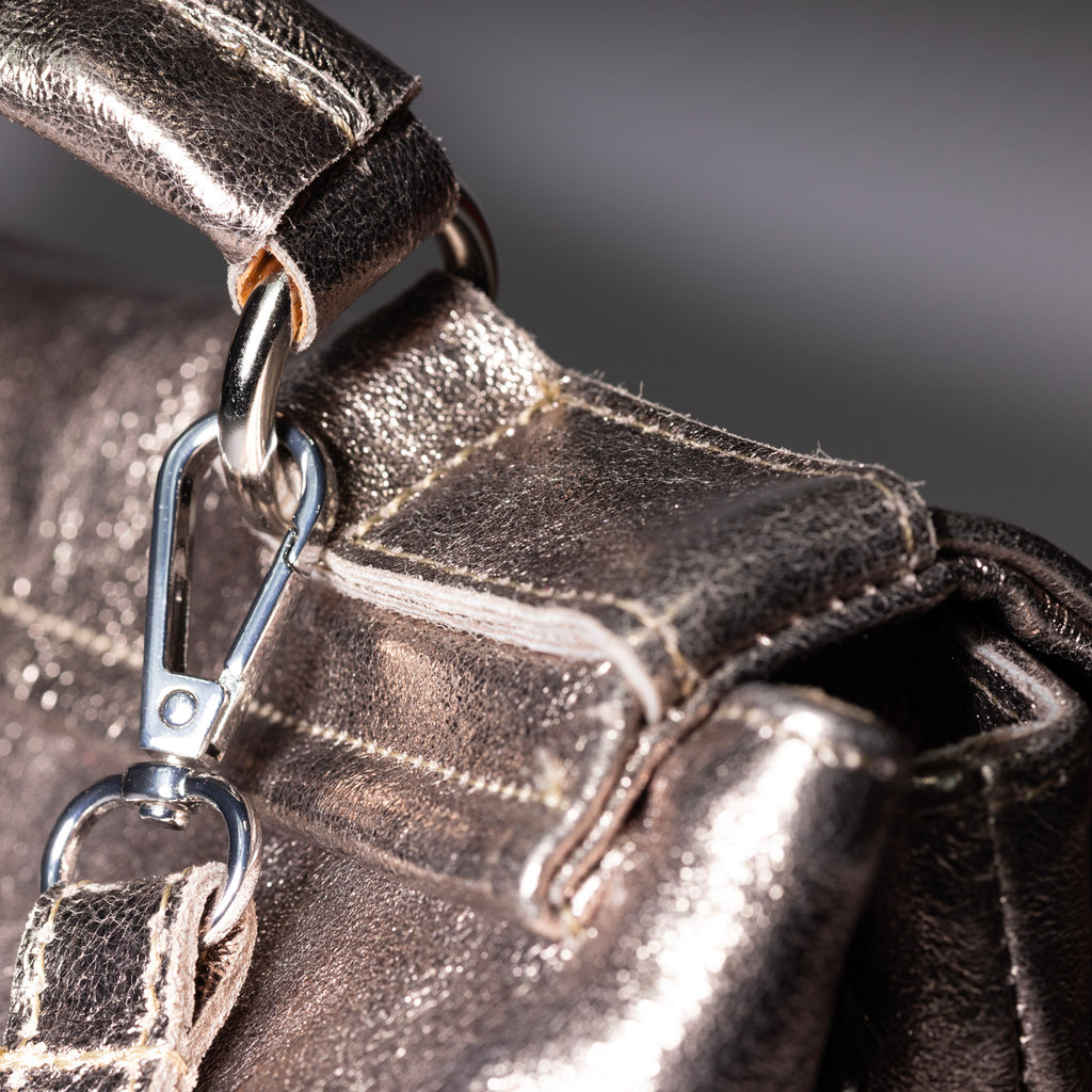 Metallic leather handbag side profile view
