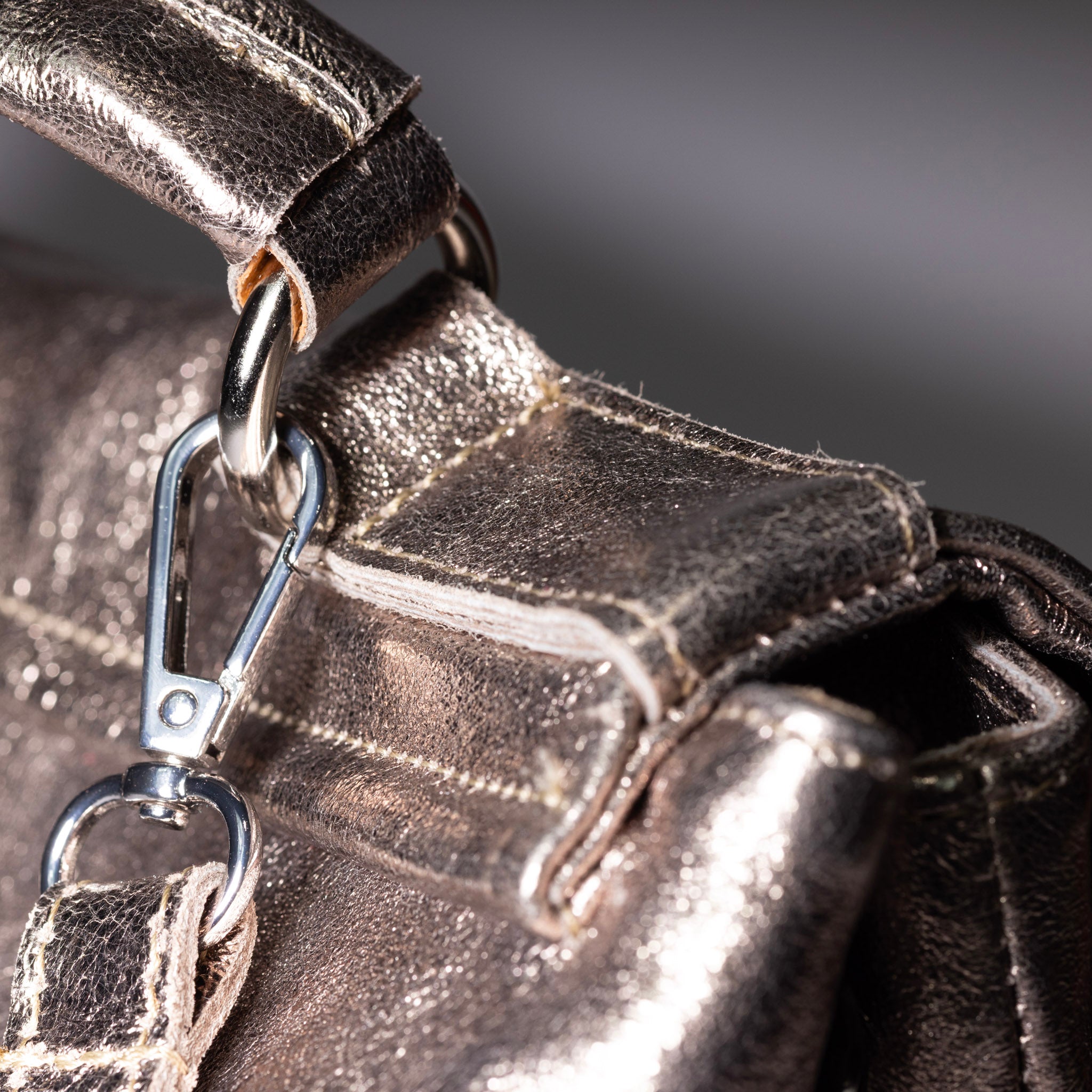 Metallic leather handbag side profile view