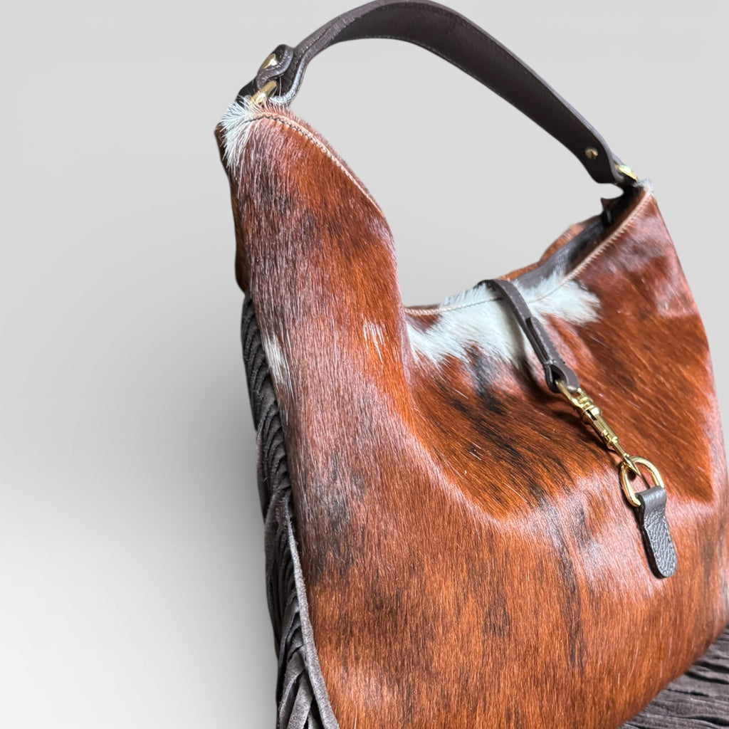 Side view of handmade Italian hair calf leather fringe shoulder bag.