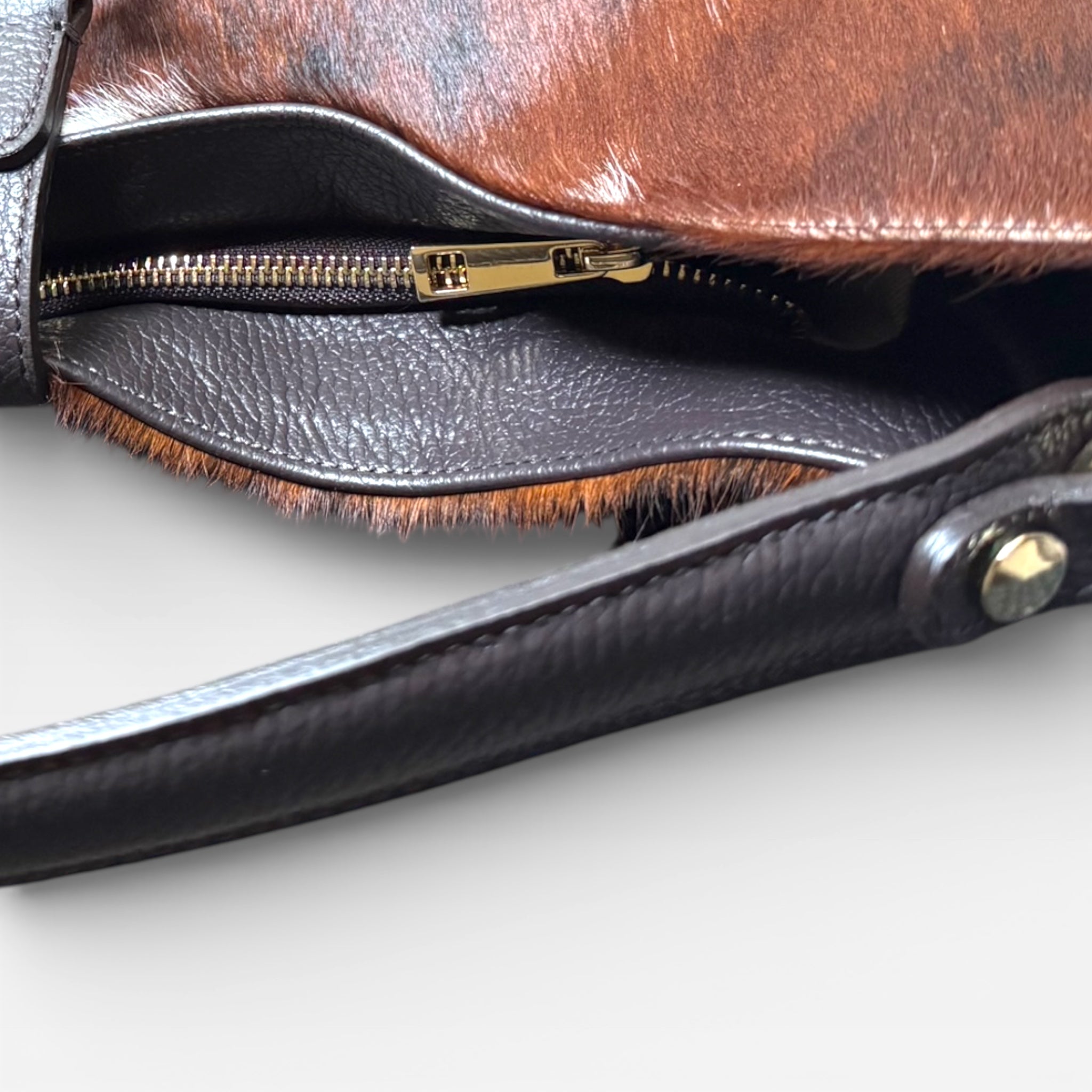 italian hair calf leather shoulder bag with elegant leather handle detailing.
