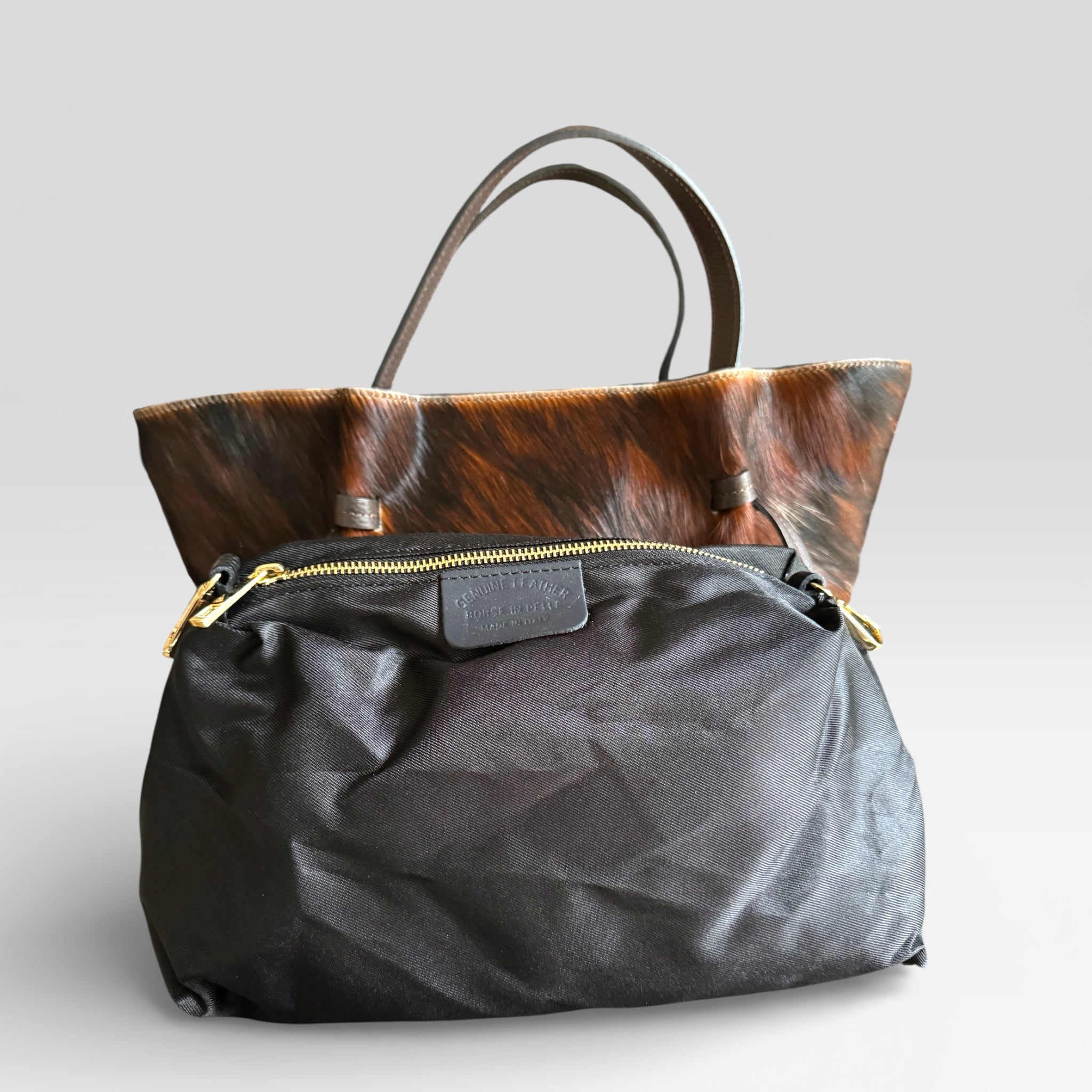 Interior of Italian leather tote bag featuring spacious fabric lining and secure zipper pocket.