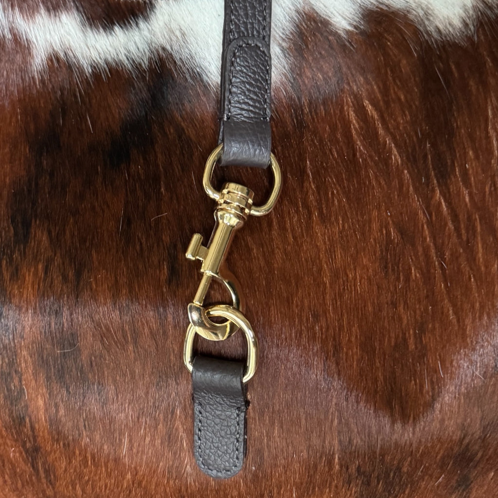 lose-up of gold-tone hardware on genuine Italian hair calf leather handbag.