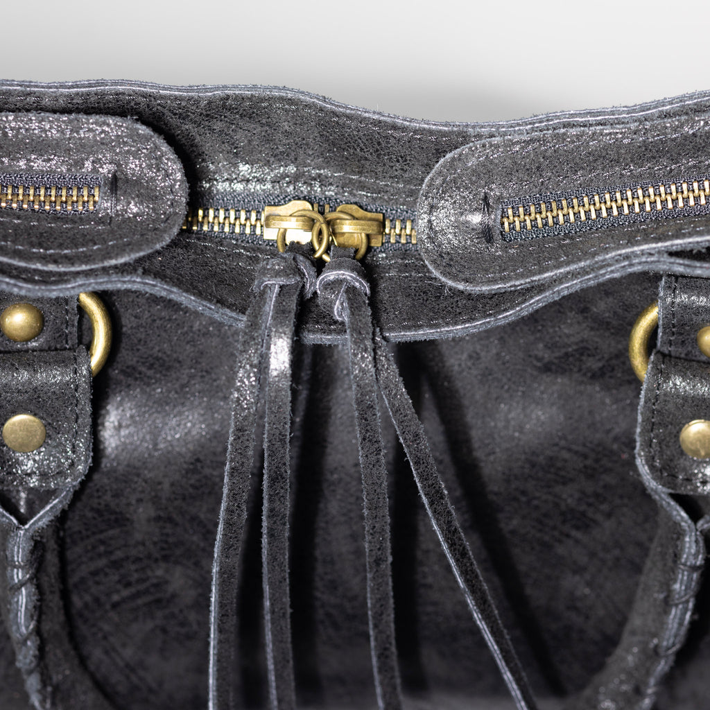 Distressed leather zipper and artisan craftsmanship detail