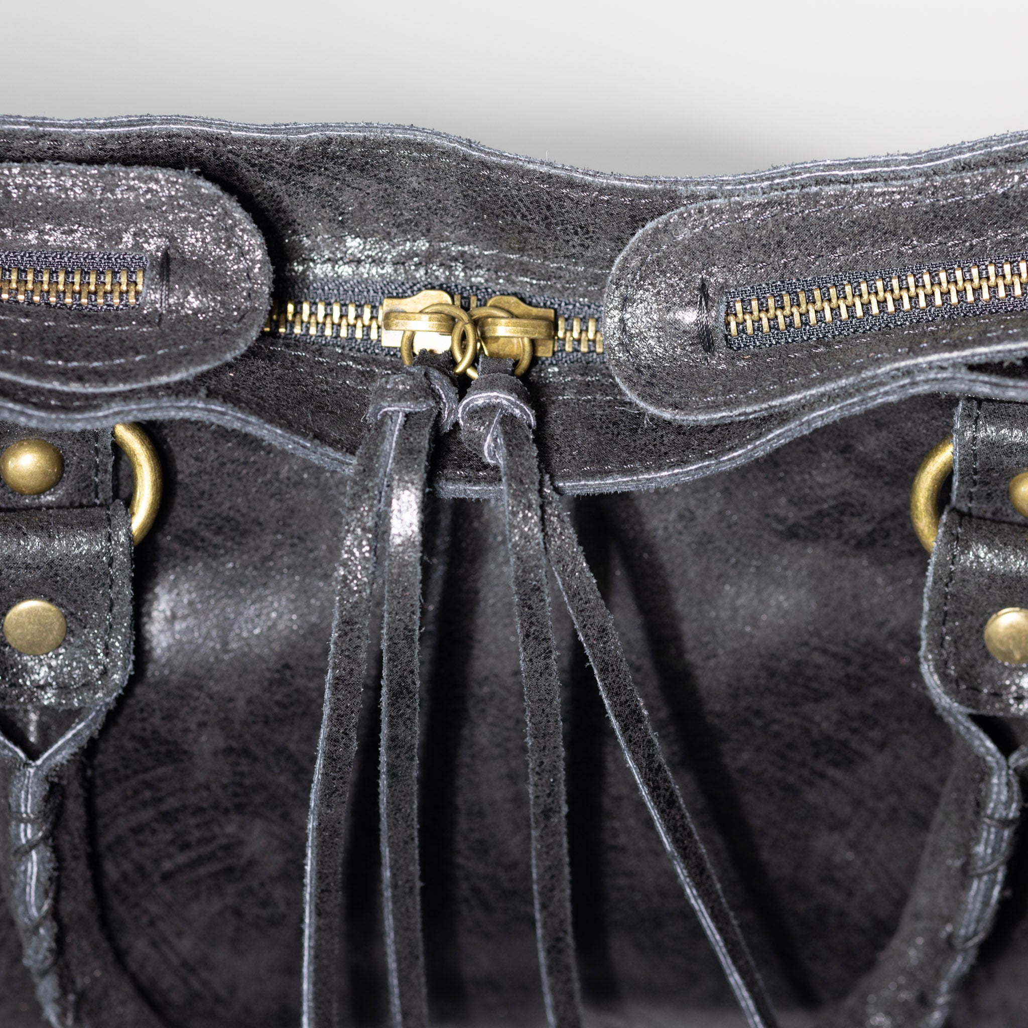 Distressed leather zipper and artisan craftsmanship detail