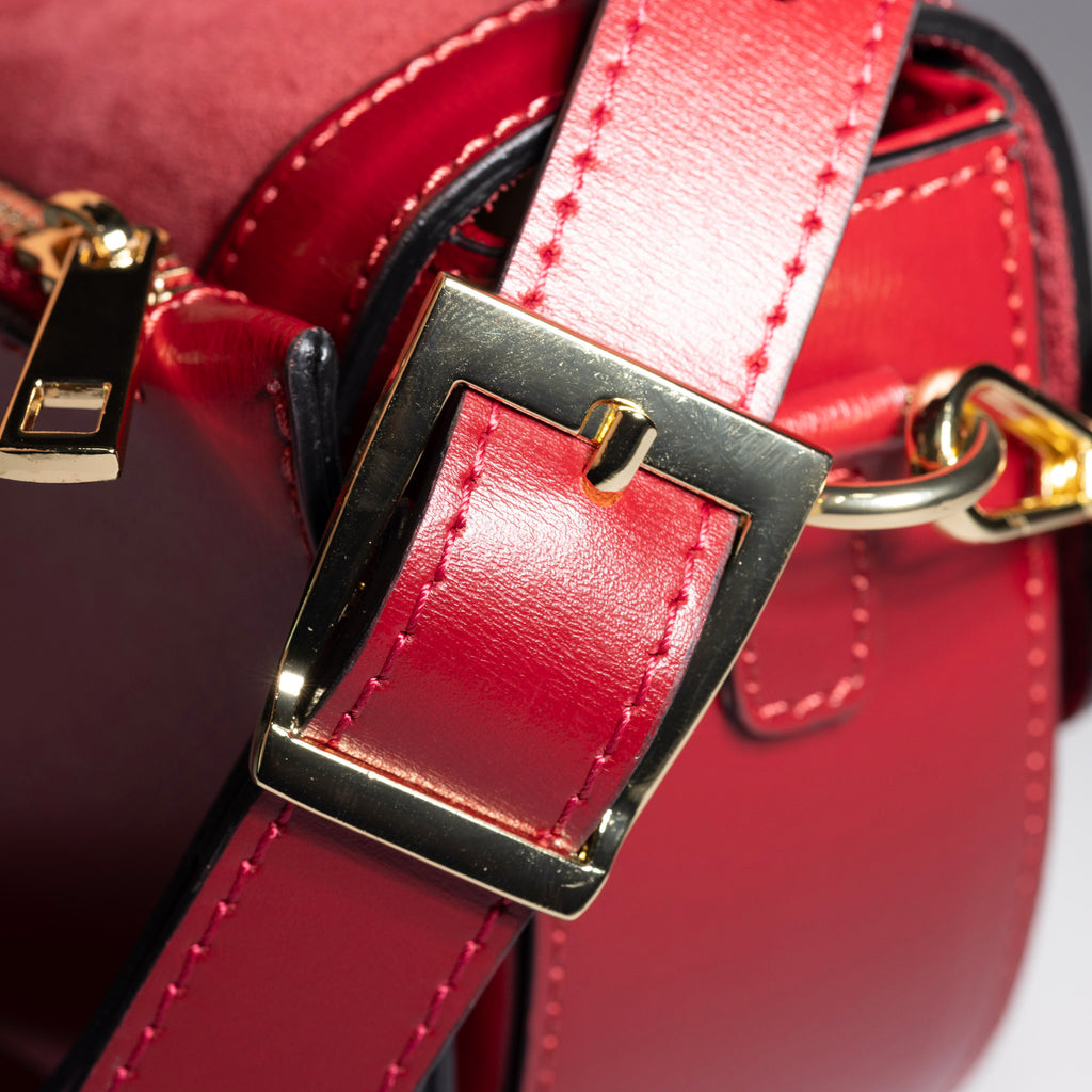 gold hardware detail on suede leather handbag
